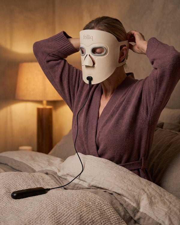 Woman fastening the strap of the mask with her eyes closed