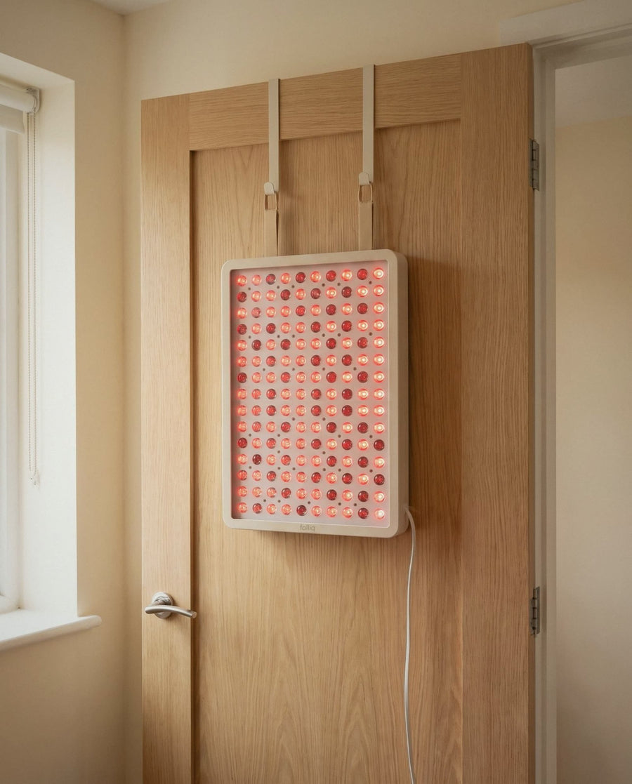 Folliq Red Light Therapy Panel hanging on the over-door kit