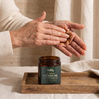 Warming Folliq batana paste between the palms before applying it to the hair