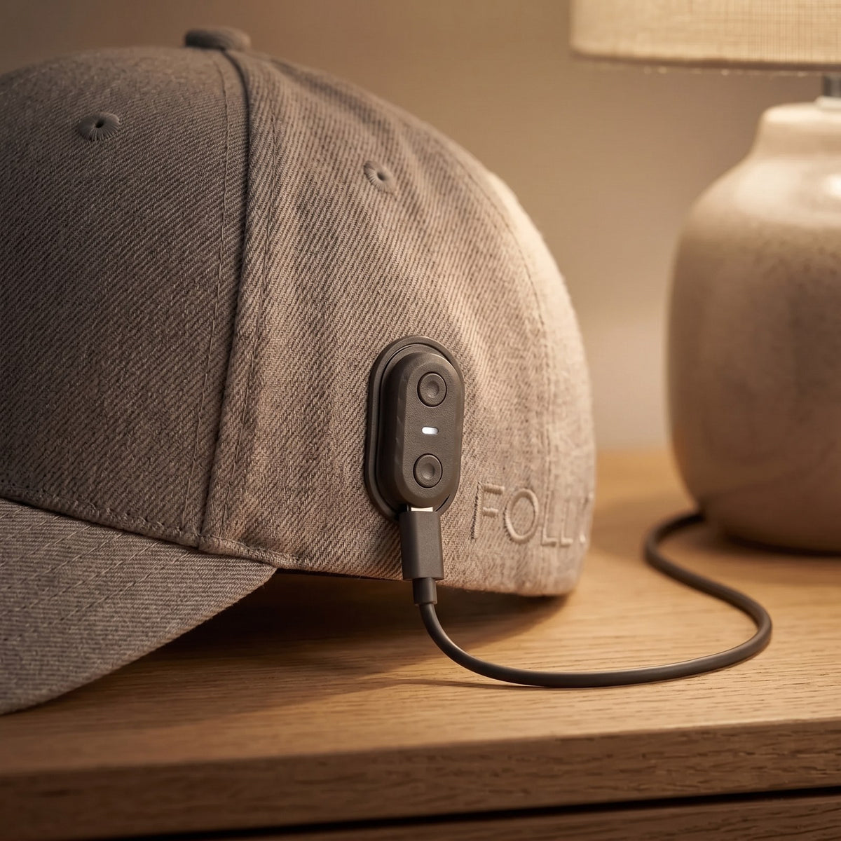 Folliq cap charging through the USB-C port on its side control module