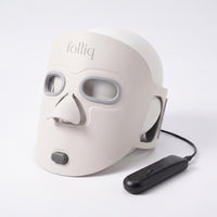 Folliq Red Light Therapy Face Mask in ivory with its controller and cable, on white