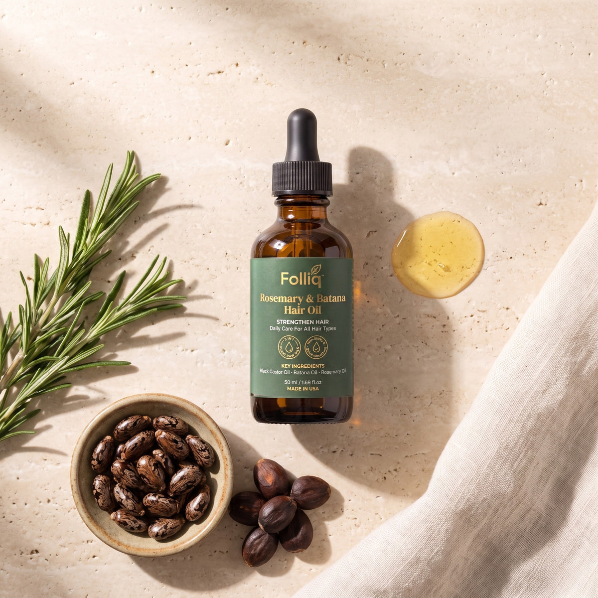 Folliq Rosemary & Batana Hair Oil with rosemary sprigs, castor beans and batana kernels