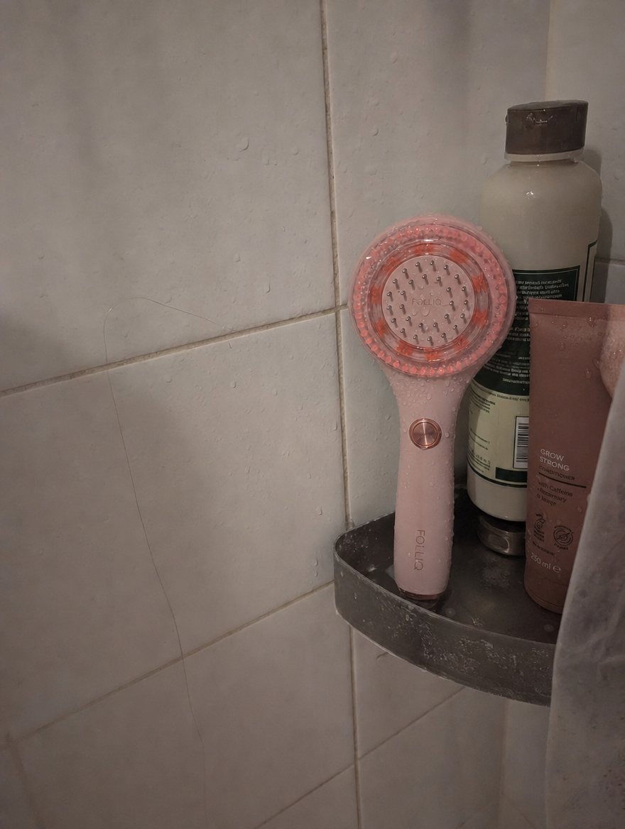 The massager hanging in the shower